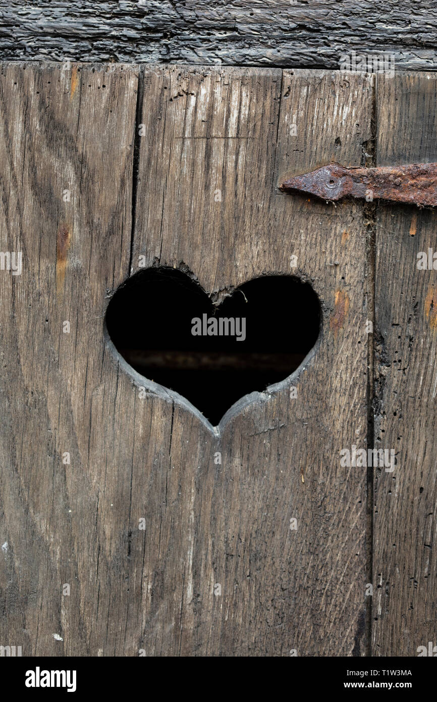 Heart shape on an old door. Stock Photo