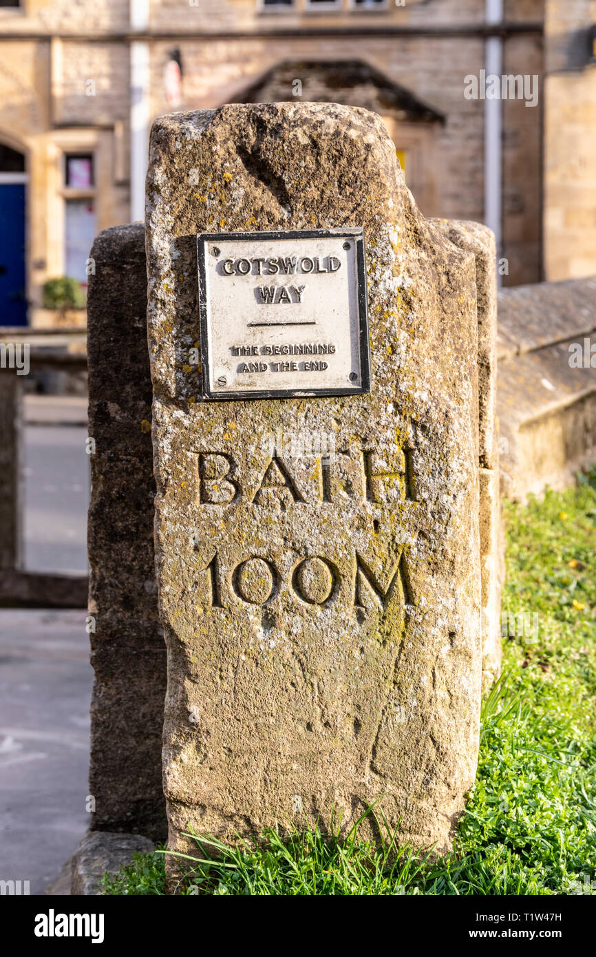 Evening light on the stone marker post depicting the beginning and the end of the Cotswold Way National Trail at Chipping Campden, Gloucestershire UK Stock Photo