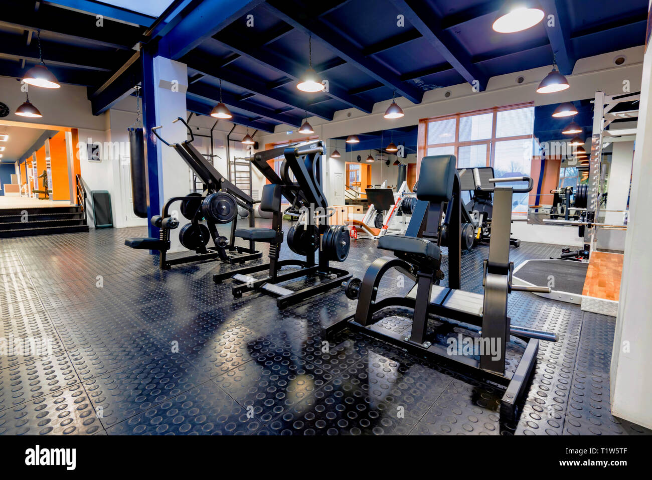 New fitness machines in modern gym interior Stock Photo
