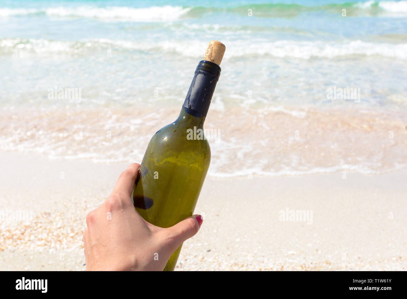 Bottle of wine in sand on the beach Stock Photo - Alamy