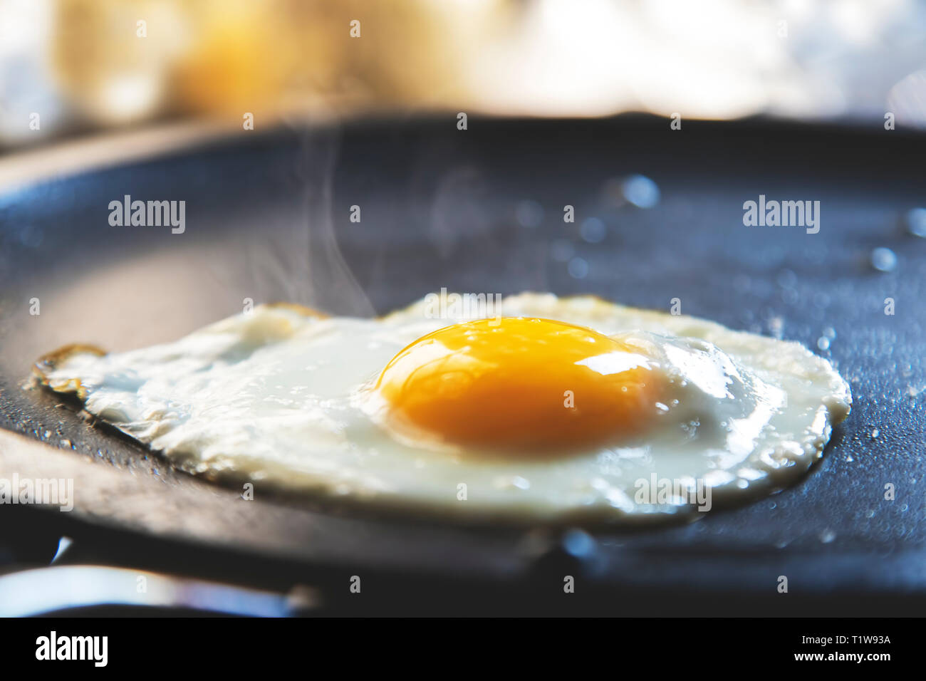 Fried egg on frying pan Stock Photo