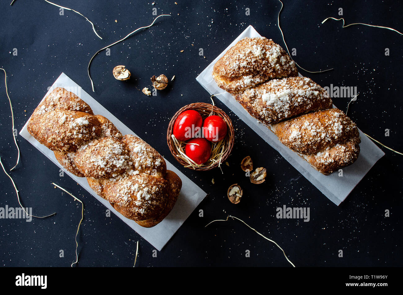 Easter Breads with decorated red painted eggs and wallnuts on dark background Stock Photo
