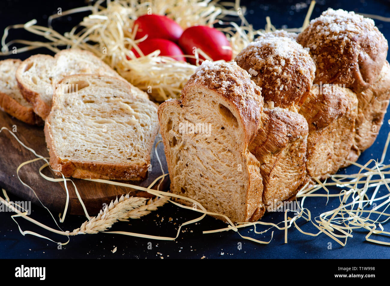 Easter Breads with decorated red painted eggs on dark background Stock Photo