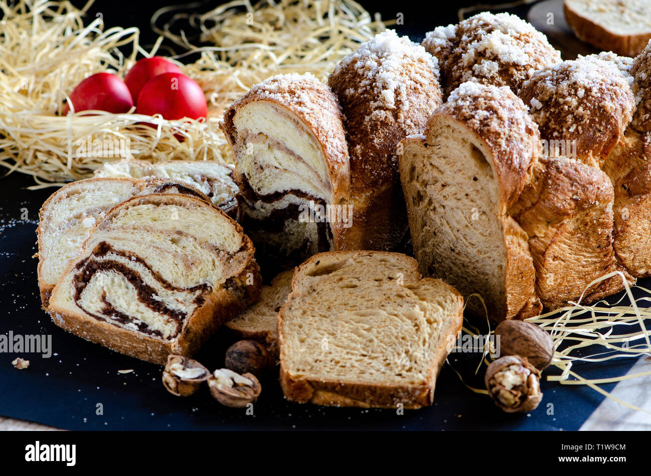 Easter Breads with decorated red painted eggs on dark background Stock Photo