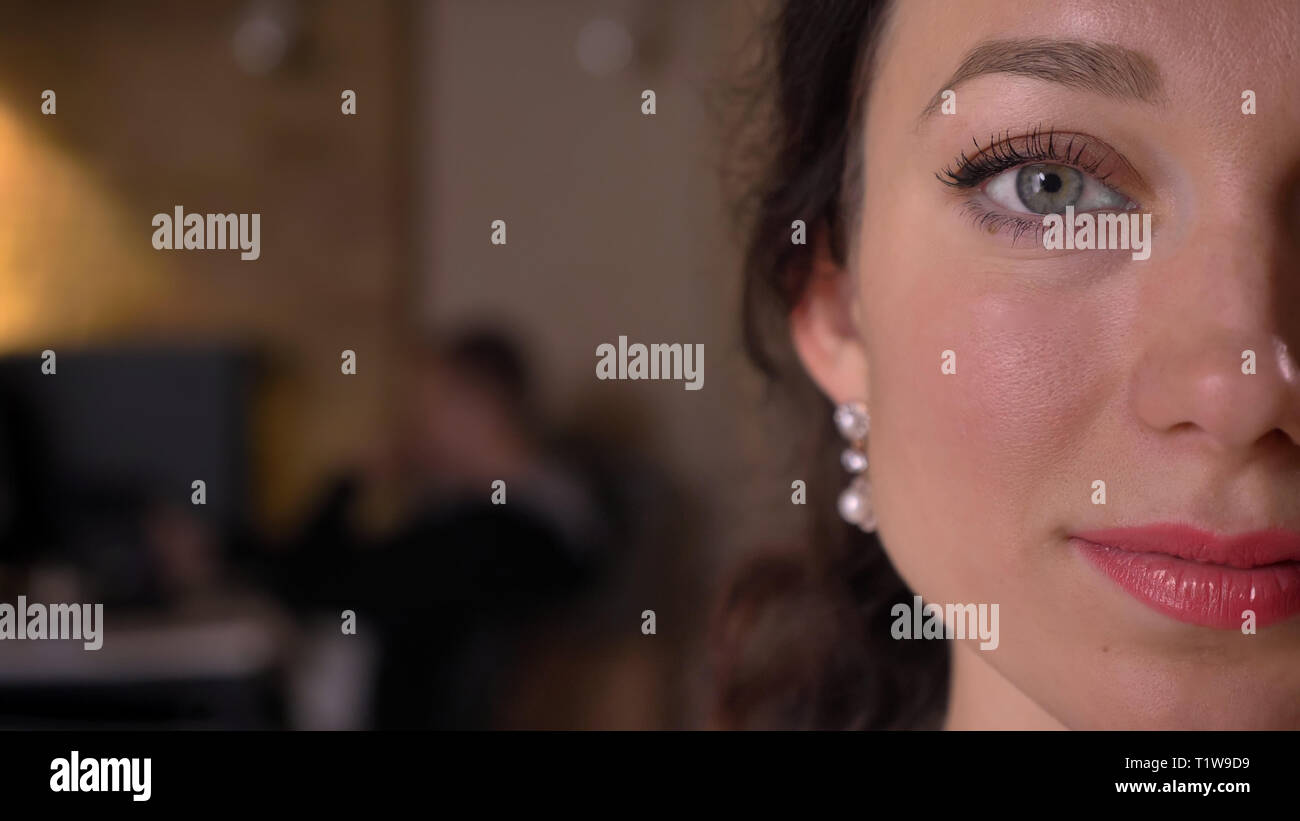 Closeup halfface shoot of young pretty caucasian female face with eyes