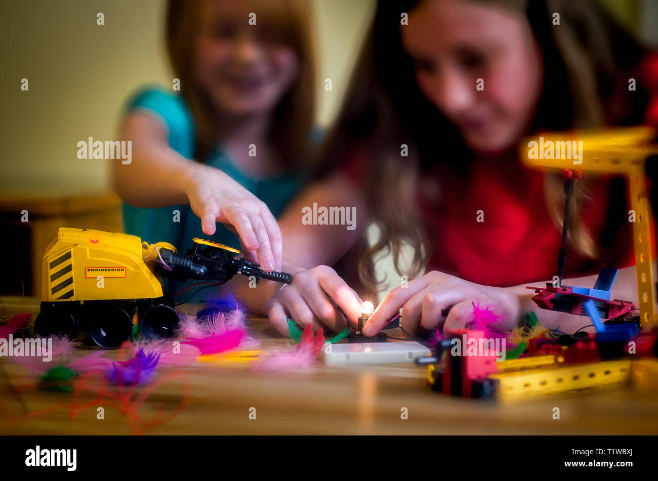 Two Girls Play With Science and Technology Kits Stock Photo
