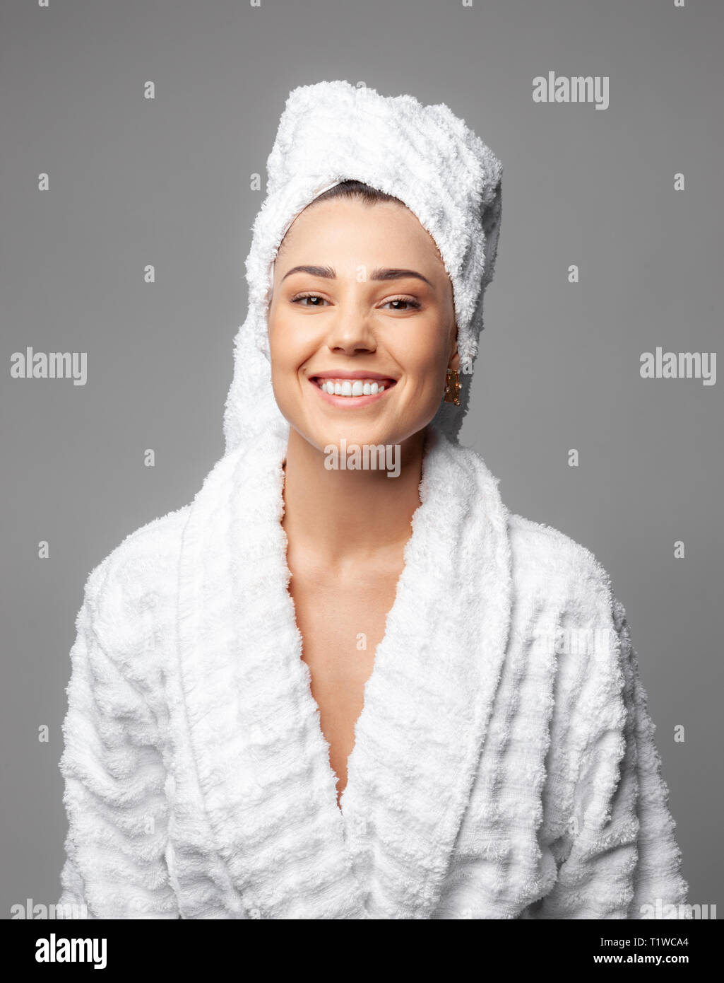 Cute girl wearing bathrobe towel hires stock photography and images