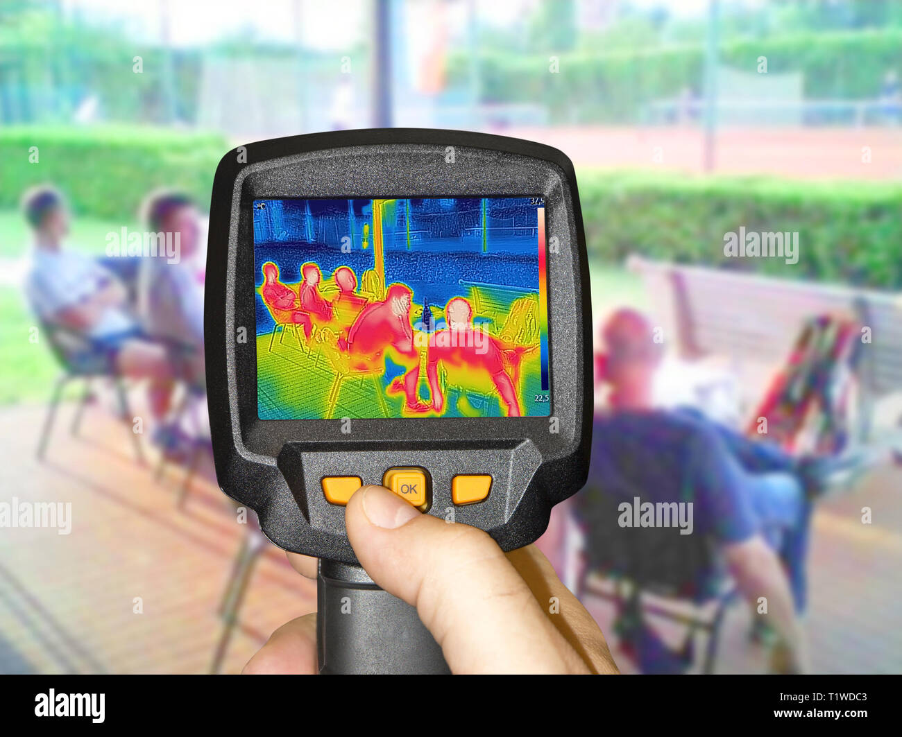 Recording whit Infrared thermovision camera when People sit at the table in the summer Stock Photo