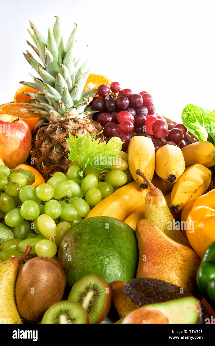 Verschiedene Obst- und Gemuesesorten liegen aufgetuermt. Stock Photo