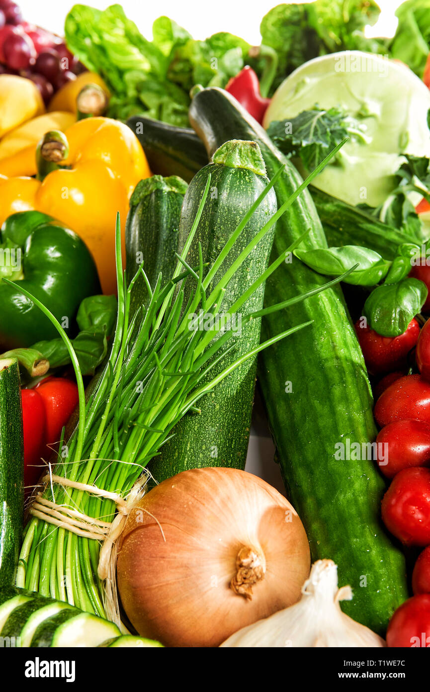 Verschiedene Obst- und Gemuesesorten liegen aufgetuermt. Stock Photo