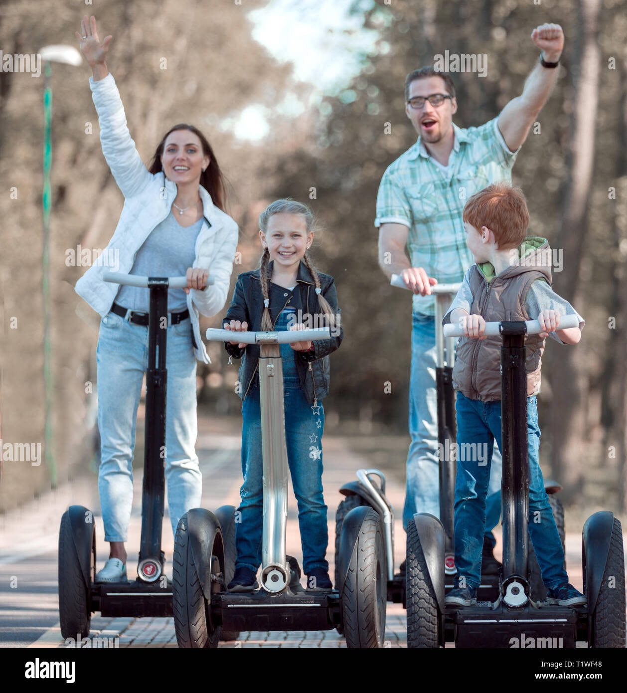 modern family riding an electric mini hoverboard in the Park Stock Photo -  Alamy