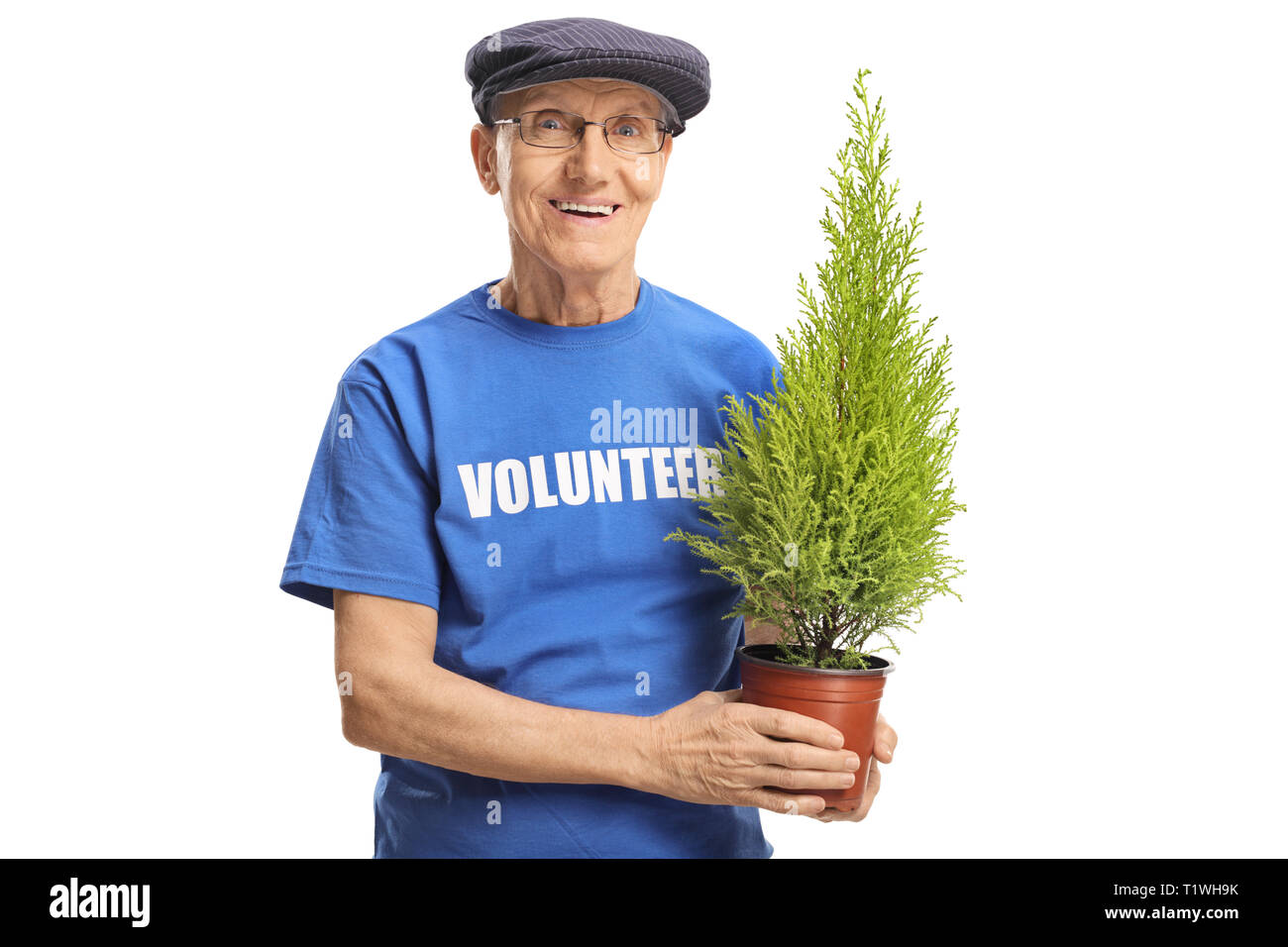 Senior man volunteer holding a plant and smiling isolated on white background Stock Photo