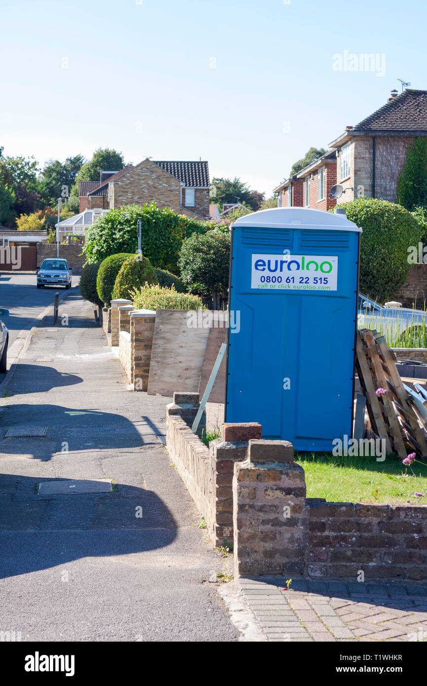 A portable toilet in the front garden of a house being renovated Stock Photo
