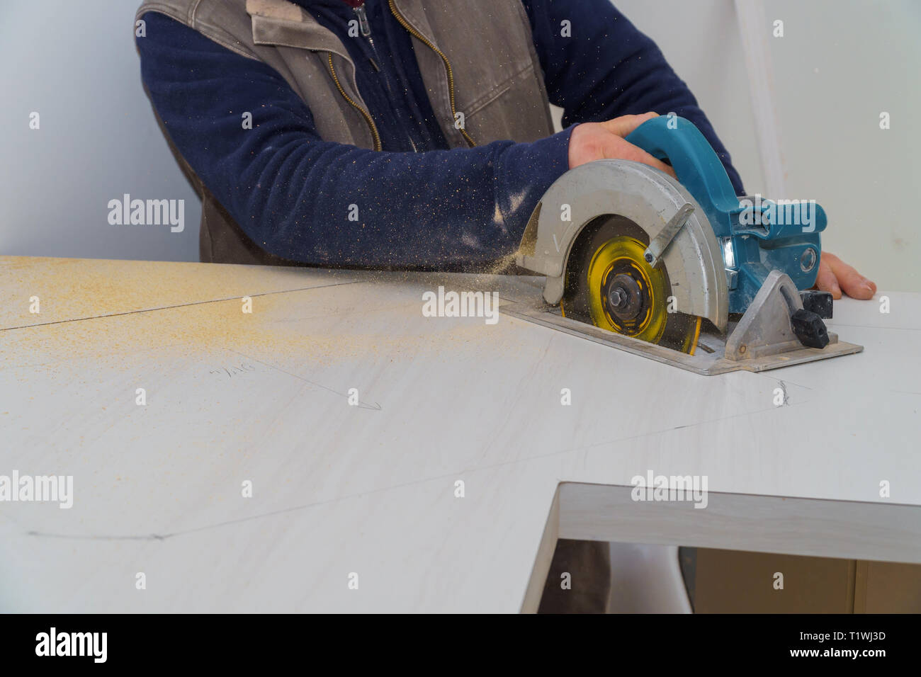 Kitchen remodel using electric saw to cut a laminate kitchen formica