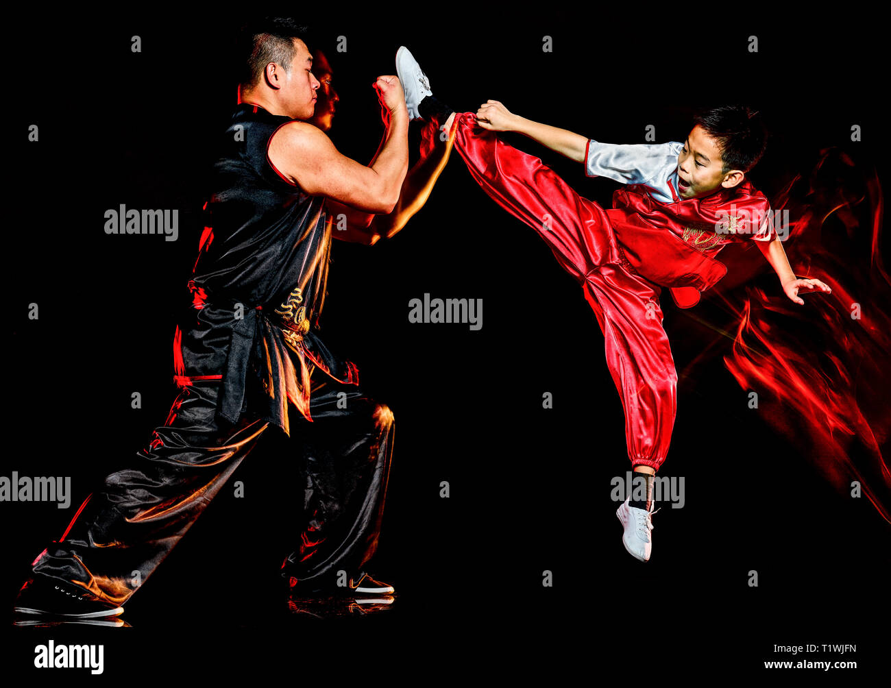 wushu chinese boxing kung fu Hung Gar fighter isolated child and man isolated on black background with speed light painting effect motion blur Stock Photo