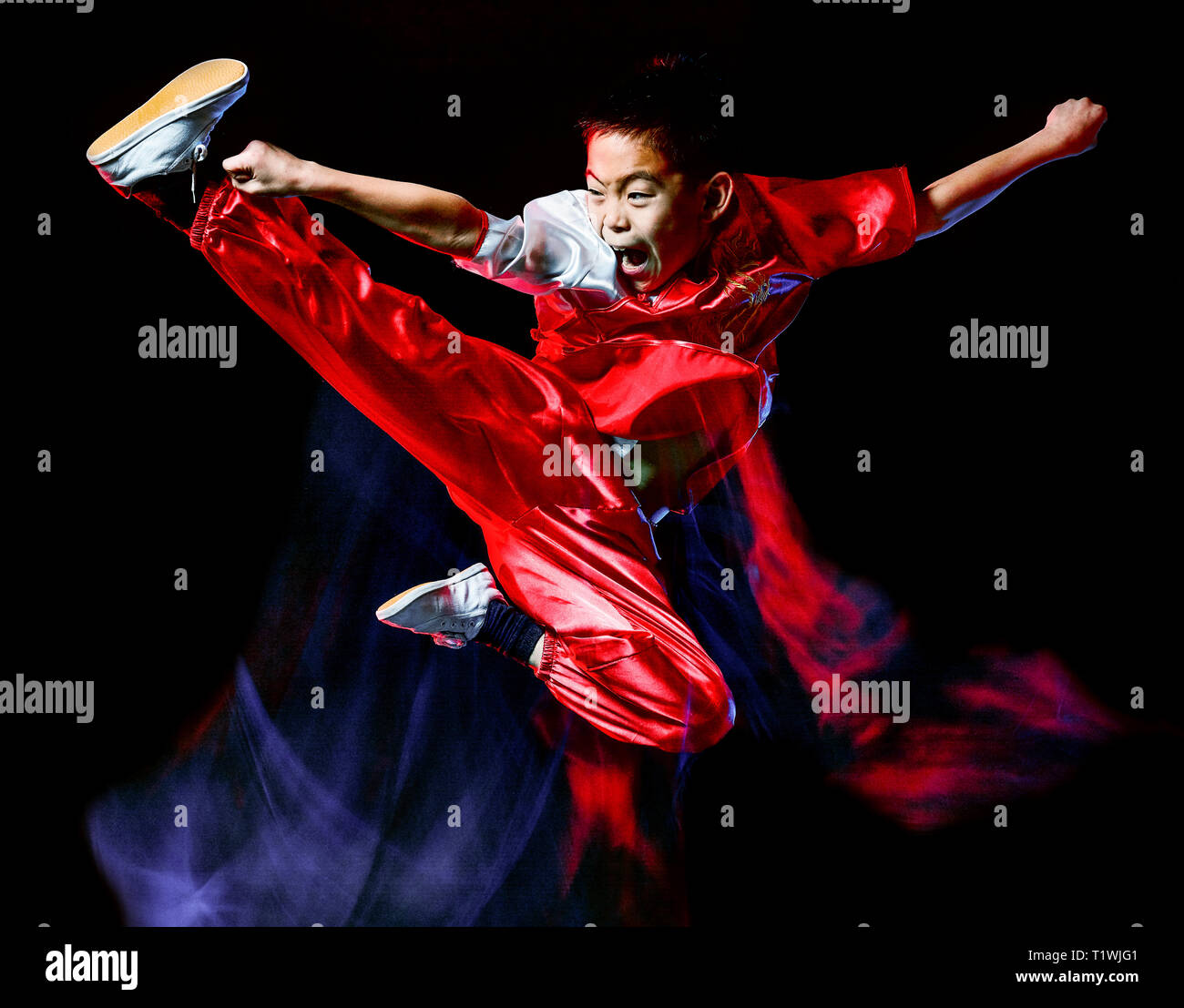 wushu chinese boxing kung fu Hung Gar fighter isolated child isolated on black background with speed light painting effect motion blur Stock Photo