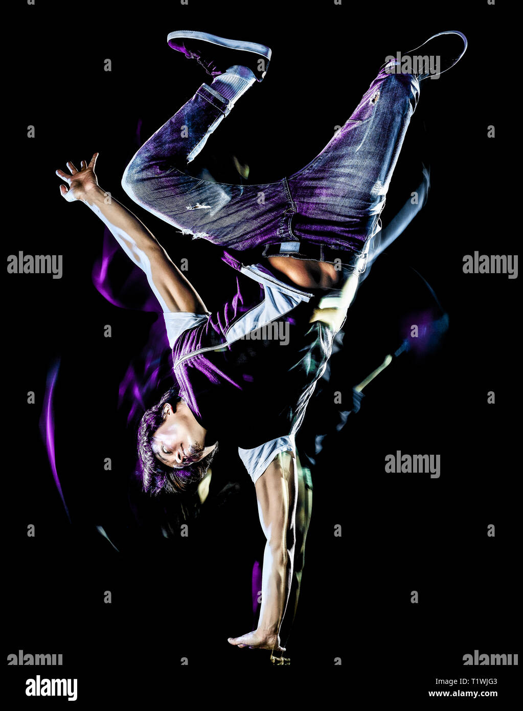 one chinese young man hip hop break dancer dancing isolated on black background with speed light painting effect motion blur Stock Photo