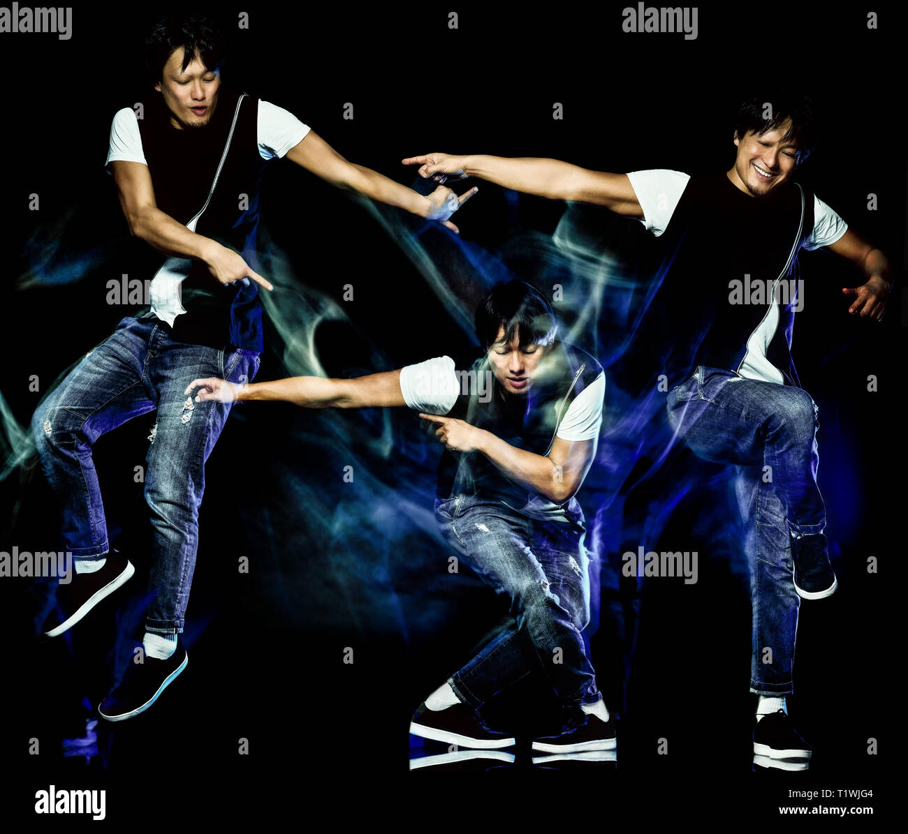 one chinese young man hip hop break dancer dancing isolated on black background with speed light painting effect motion blur Stock Photo