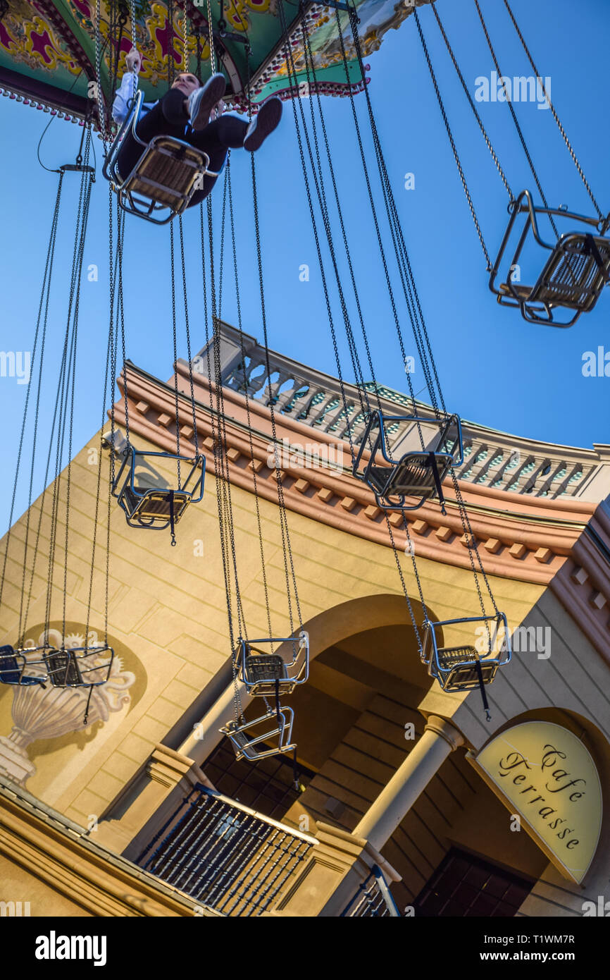 Vienna, Austria - September , 16, 2019: Side view of kids having fun at spinning Luftikus carousel or chain swing ride, in Prater amusement park Stock Photo