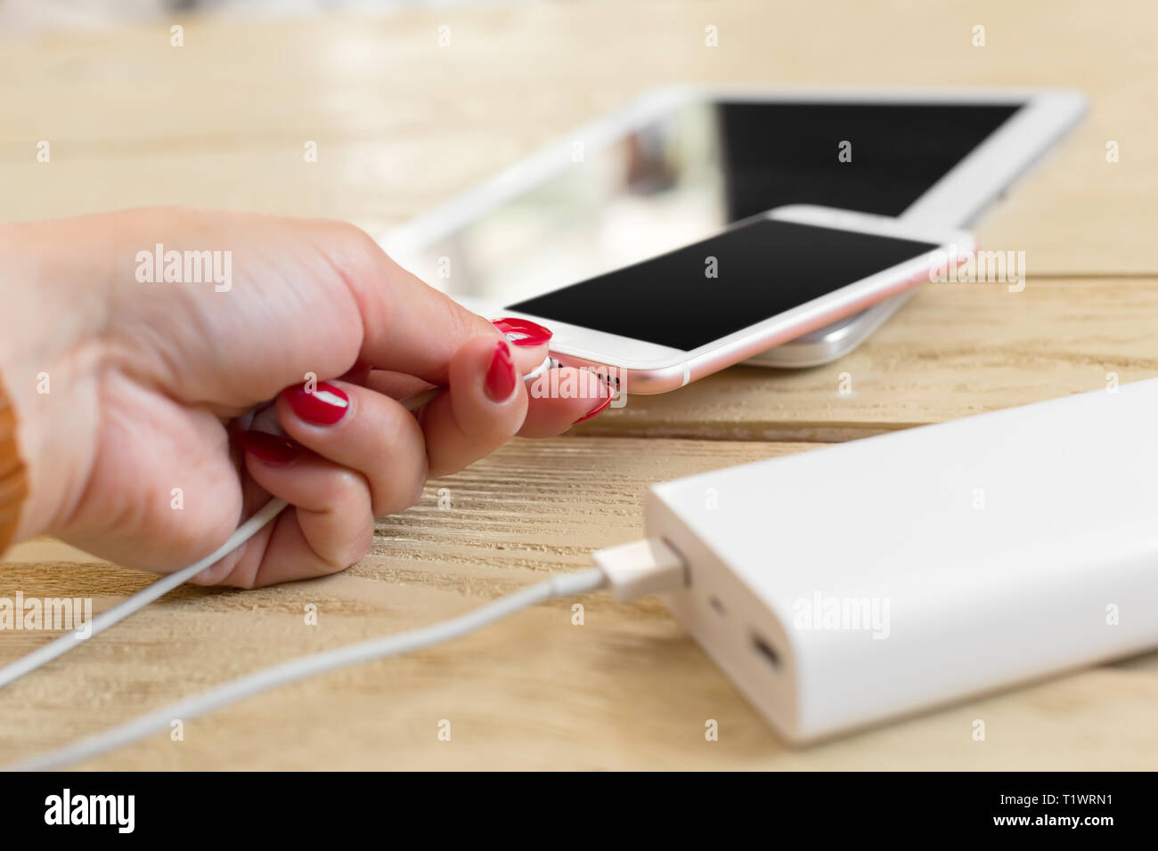 Smartphone charging with power bank Stock Photo Alamy