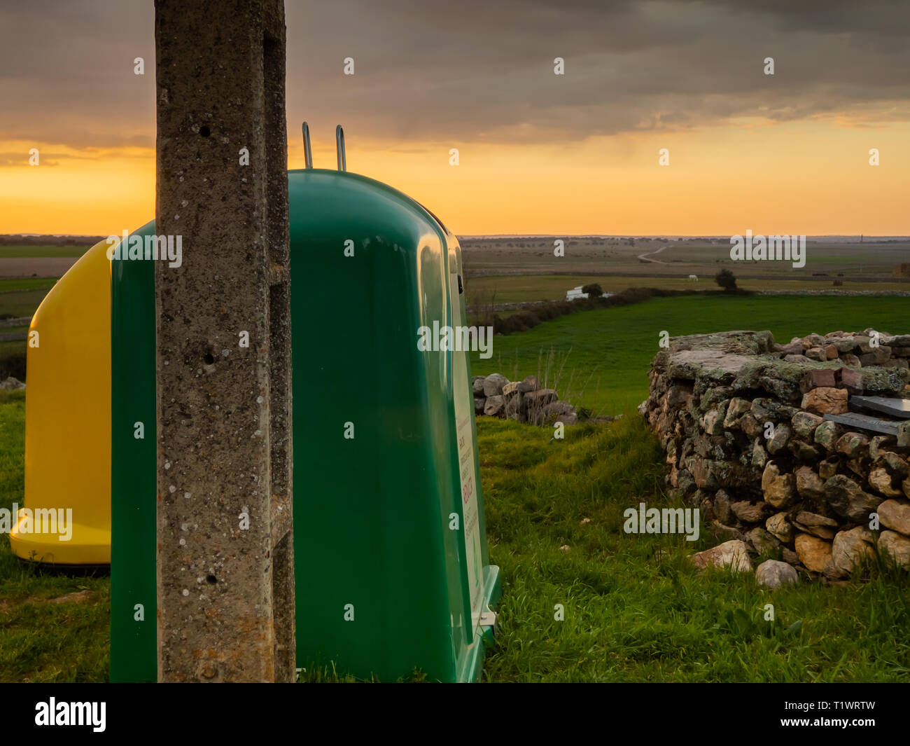 Glass and plastic recycling bins in the field Stock Photo - Alamy