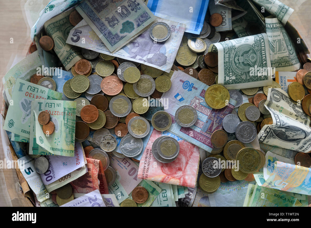 Coins and notes from different countries in a box at Brussels Airport (or Zaventem), in Belgium *** Local Caption *** Stock Photo