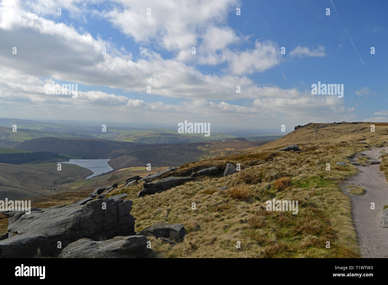 Two people walking a dog on Kinder Scout Stock Photo Alamy