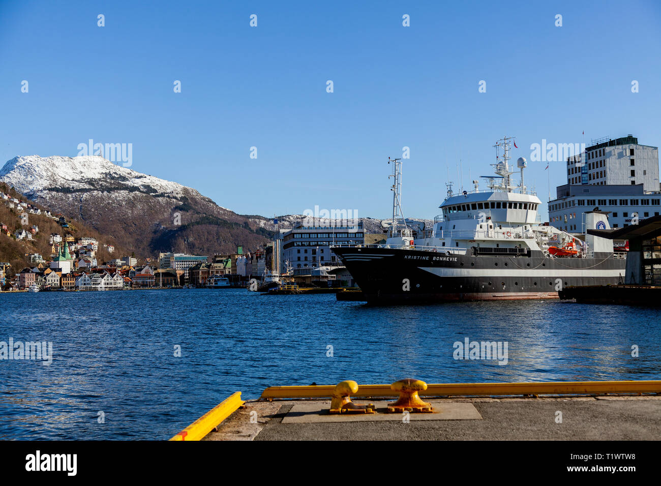 Ocean research vessel Kristine Bonneviein the port of Bergen, Norway. Owned by the University of Bergen, Institute of Marine Research. Snow capped Mou Stock Photo