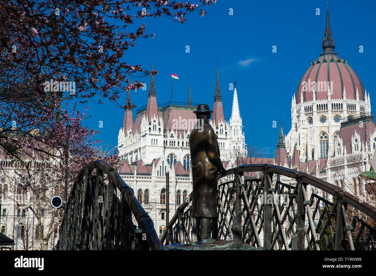 BUDAPEST, HUNGARY - APRIL, 2018: Monument to the former prime minister Imre Nagy pensively looking towards Hungary Parliament Stock Photo