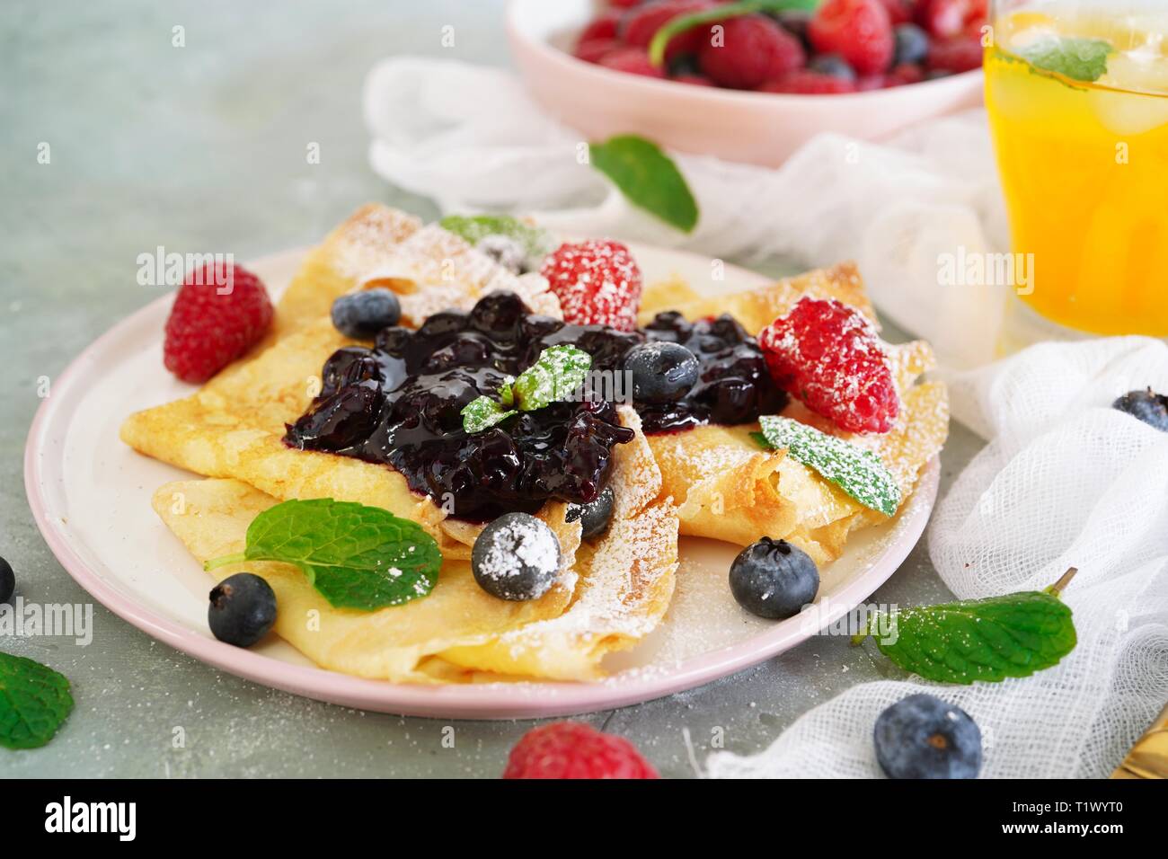 French crepes with fresh fruits and blueberry compote topping