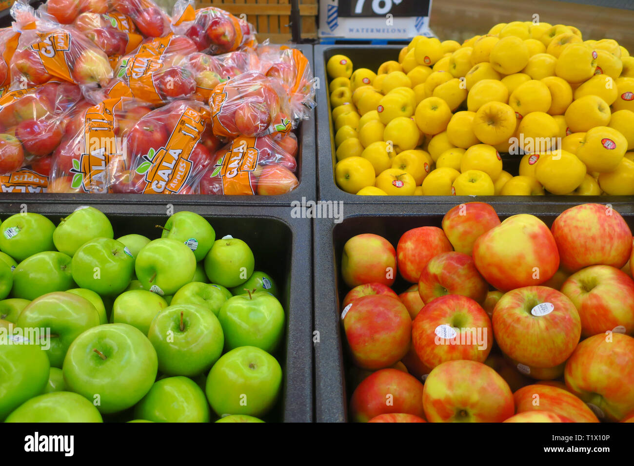 Multicolored apples in a bin Stock Photo Alamy