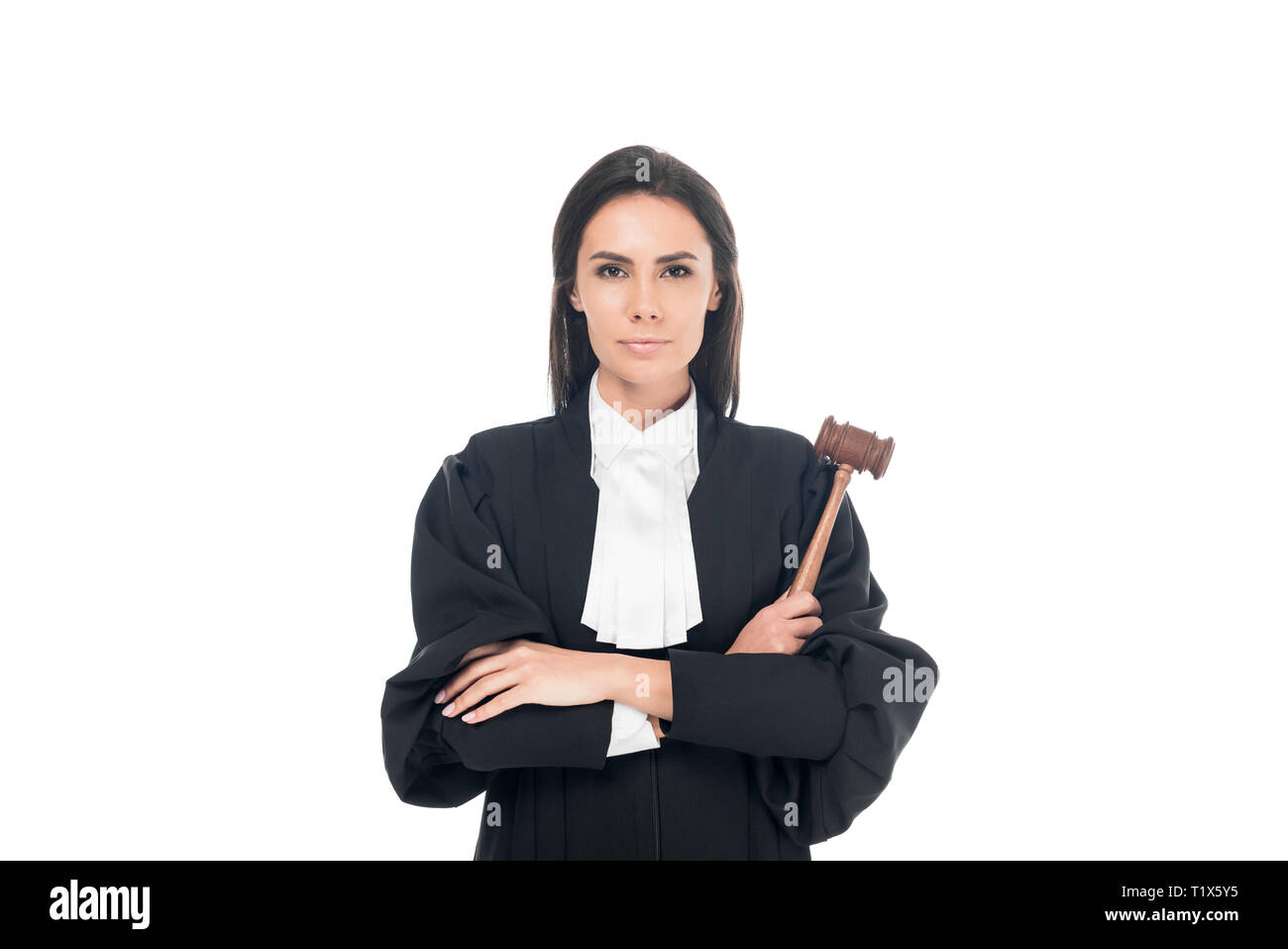 Judge in judicial robe holding gavel and standing with folded arms isolated on white Stock Photo