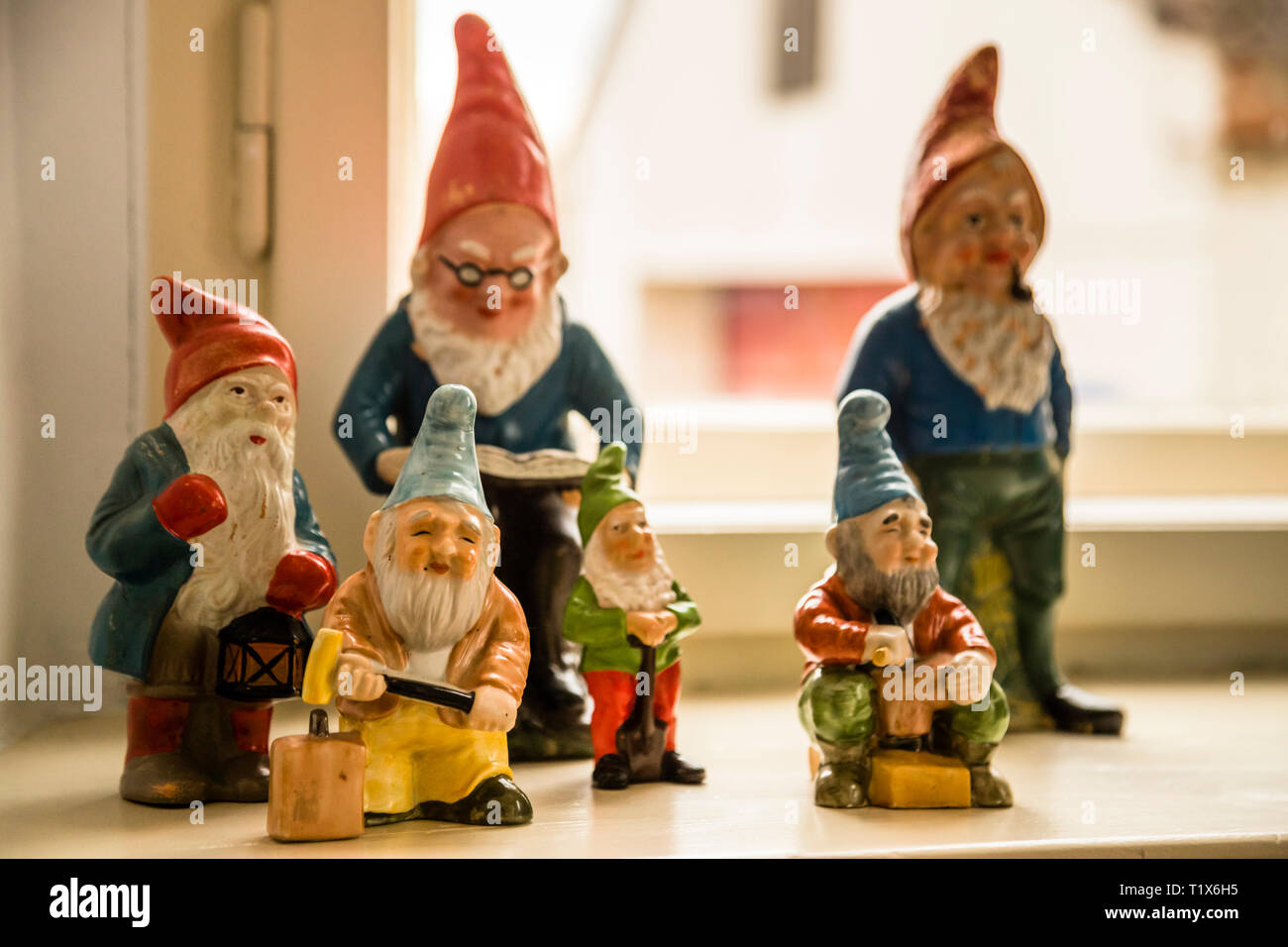 Garden gnomes on the windowsill as decoration of Kavaliershaus in Fincken, Germany Stock Photo