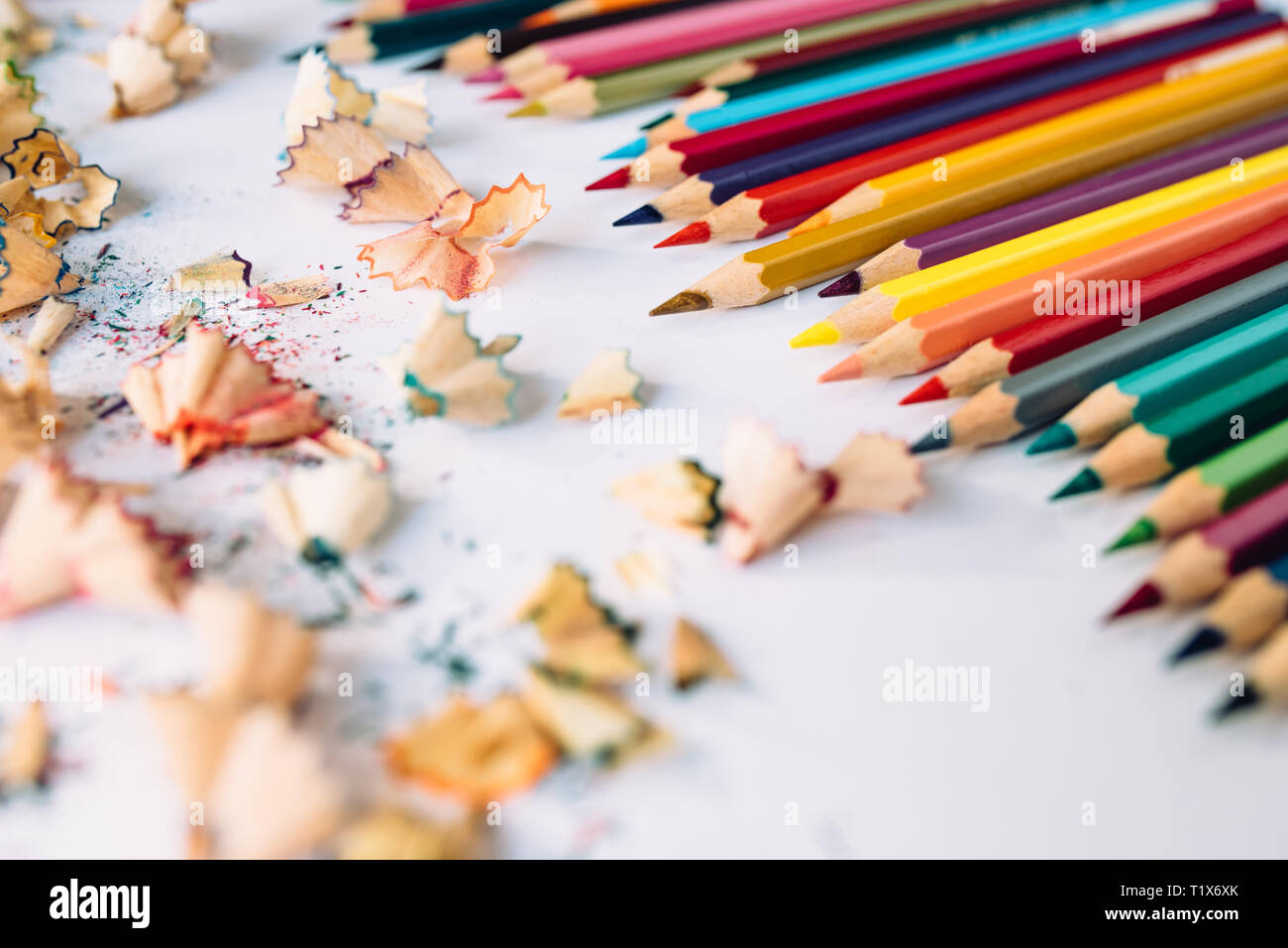 Sharpened crayons and colored shavings on paper Stock Photo