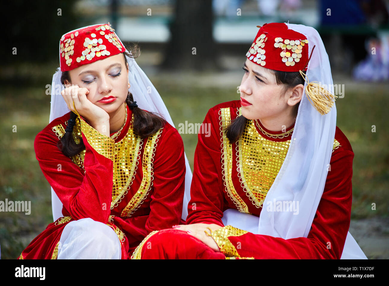 RIVNE, UKRAINE, AUGUST, 24, 2010: Two Armenian (Tatar) girls in folklore costumes are waiting for their performance at the International Folklore Fest Stock Photo