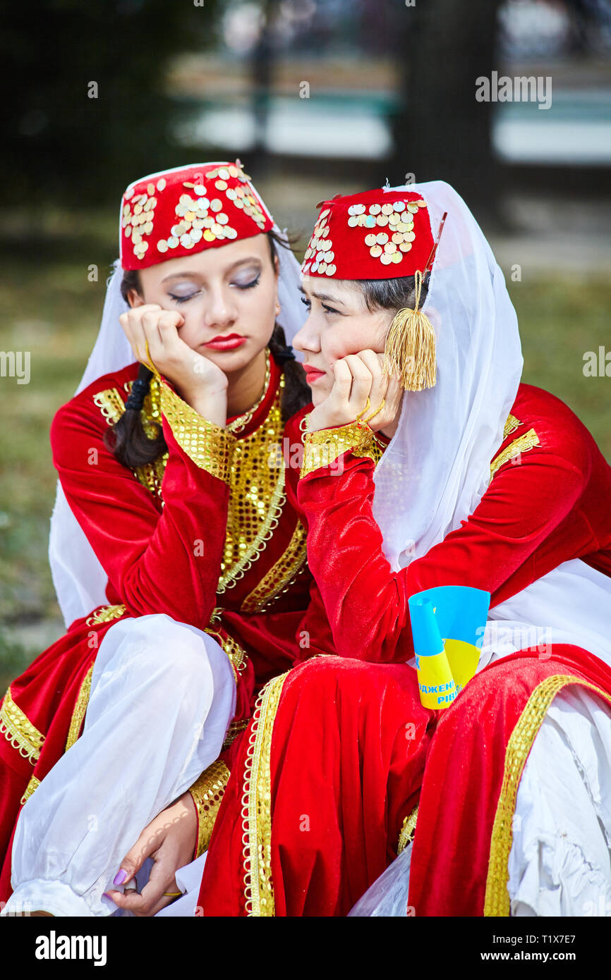 RIVNE, UKRAINE, AUGUST, 24, 2010: Two Armenian (Tatar) girls in folklore costumes are waiting for their performance at the International Folklore Fest Stock Photo