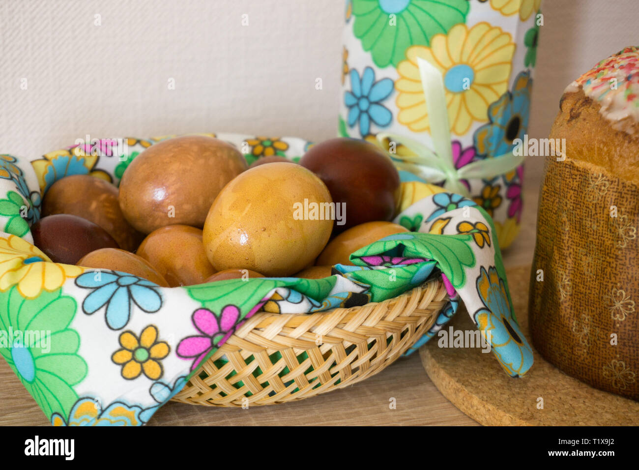 Table before Easter decorated with Easter cake, willow and eggs painted with onion peel Stock Photo