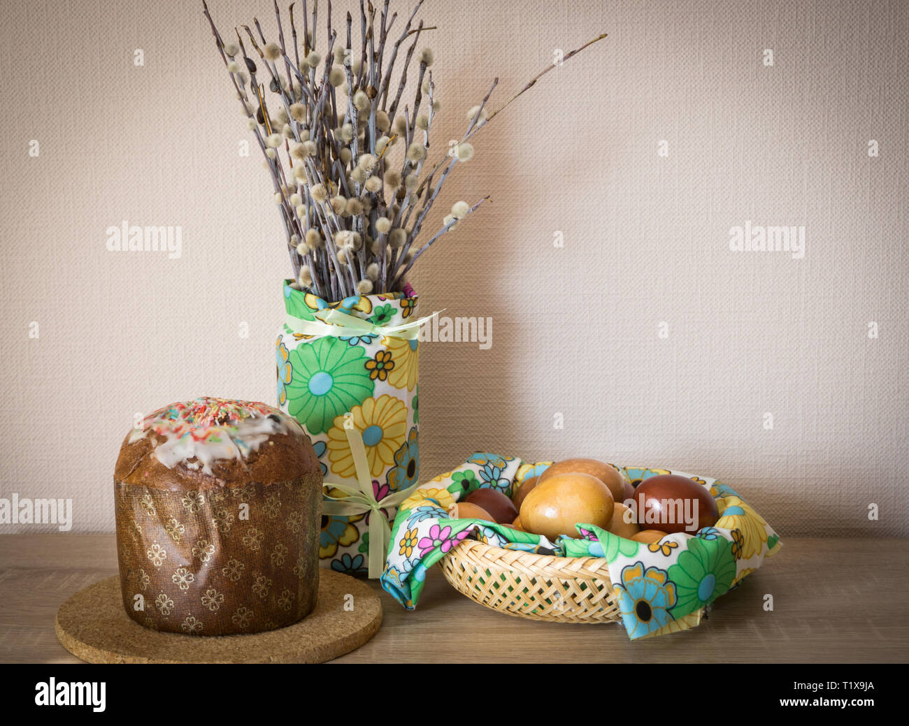 Table before Easter decorated with Easter cake, willow and eggs painted with onion peel Stock Photo