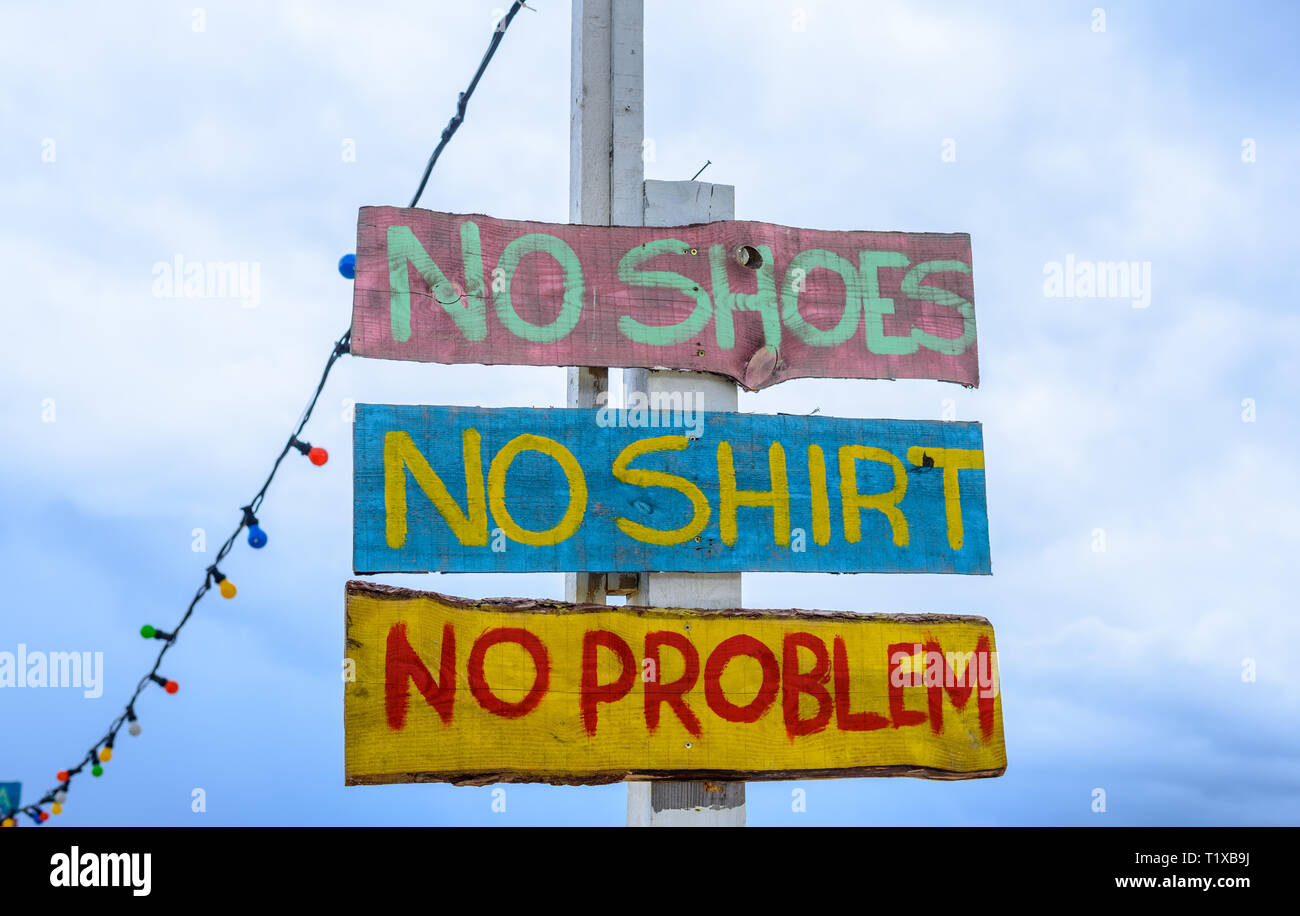 'No shoes, no shirt, no problem' sign on the beach Stock Photo