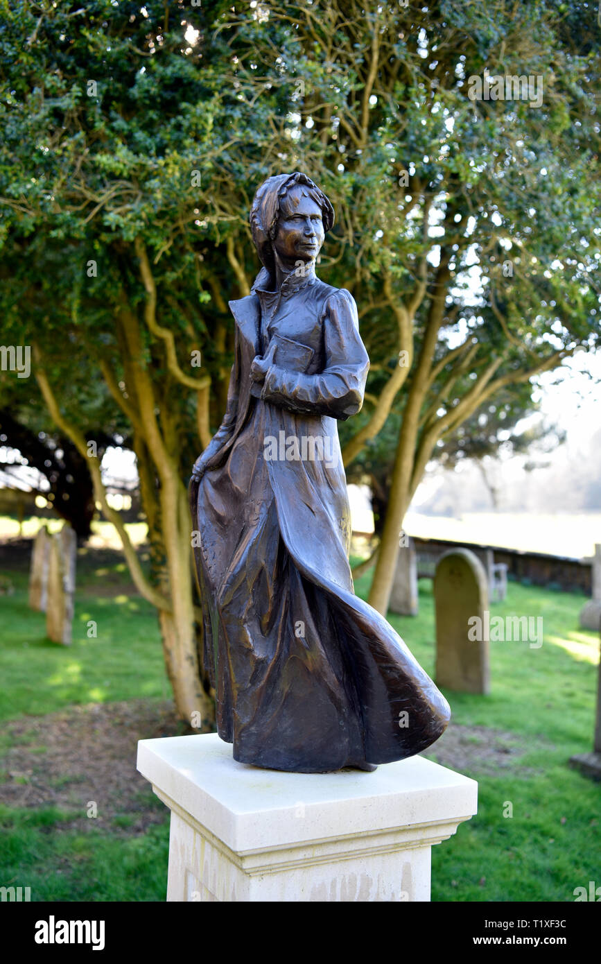 Bronze statue of Jane Austen (b.16 December 1775-d.18 July 1817) by Adam Roud in St Nicholas Church Churchyard, Chawton, near Alton, Hampshire, UK. Stock Photo