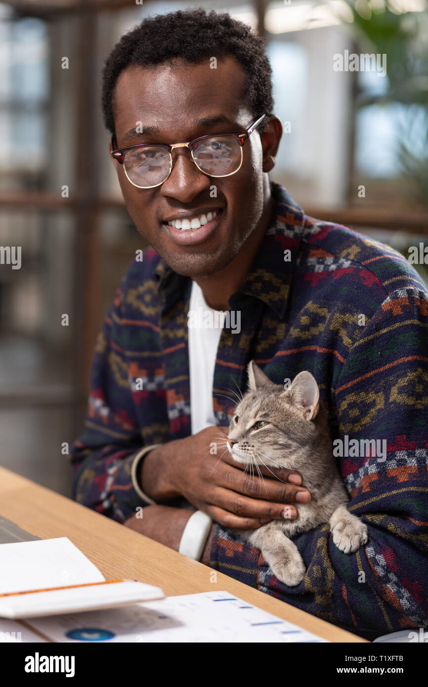 Man holding a cat in his hands Stock Photo