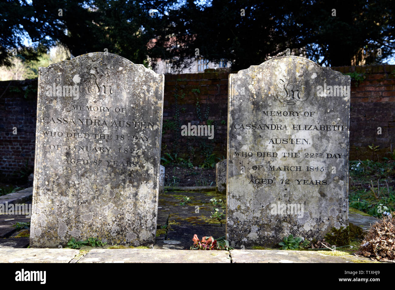 The weathered headstones of Jane Austen’s mother & sister buried in the grounds of Saint Nicholas Church, Chawton, near Alton, Hampshire, UK. Stock Photo