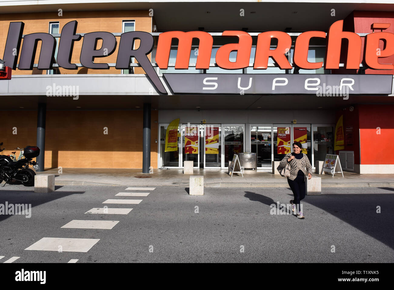 A woman is seen exiting supermarket chain Intermarche. Stock Photo