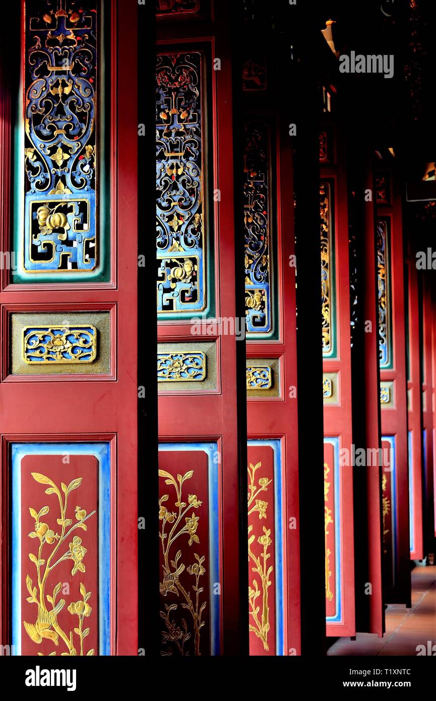 Set of beautiful traditional red, blue and yellow Chinese door panels with rich details and colours in perspective view Stock Photo