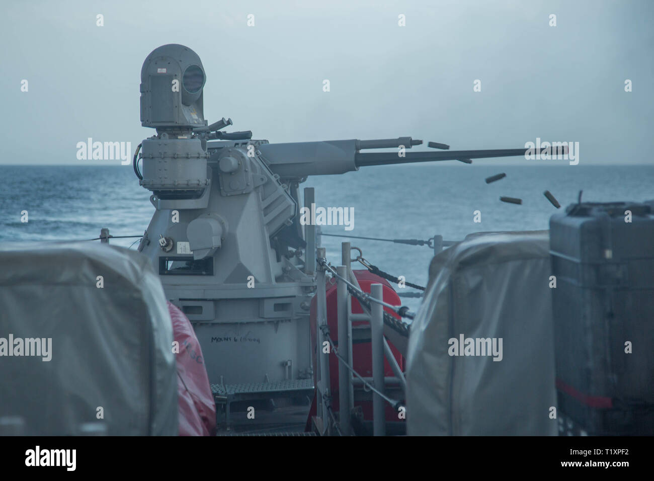 ARABIAN GULF (March 22, 2019) A Mark 38 .25mm machine gun fires during a gunnery exercise aboard the Cyclone-class coastal patrol ship USS Chinook (PC 9). The Chinook is forward-deployed to the U.S. 5th Fleet area of operations to ensure maritime stability and security in the Central Region, connecting the Mediterranean and Pacific through the western Indian Ocean and three strategic choke points. (U.S. Army photo by Spc. Dakota Young/ Released) Stock Photo