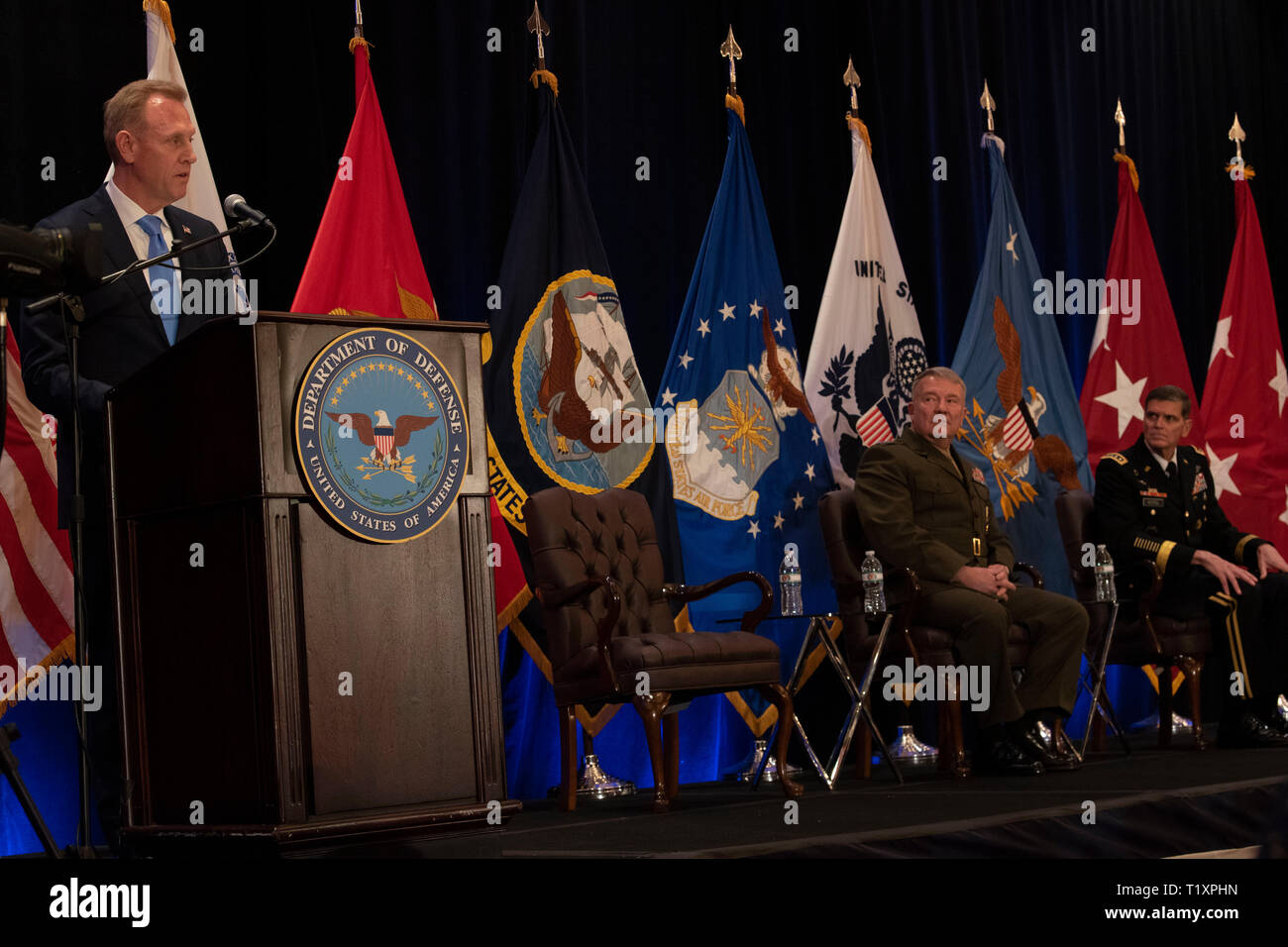 U.S. Acting Secretary of Defense Patrick M. Shanahan speaks at the U.S. Central Command change of command, Tampa, Florida, March 28, 2019. Seated are (center) the incoming commander of U.S. Central Command, U.S. Marine Corps Gen. Kenneth F. McKenzie Jr., and the outgoing Centcom commander, U.S. Army Gen. Joseph L. Votel. (DoD photo by Lisa Ferdinando) Stock Photo
