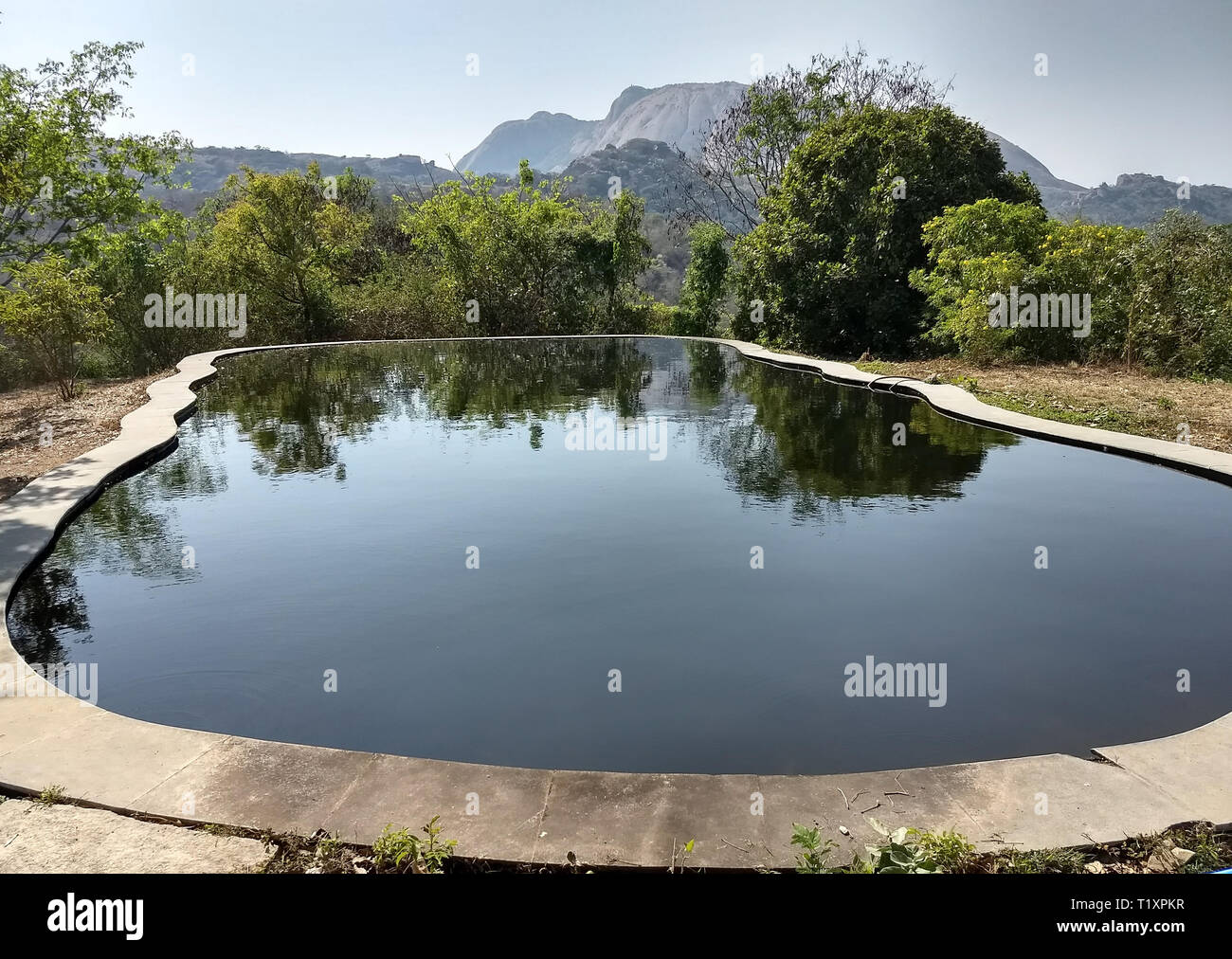 A dark dangerous swimming pool with dark unhealthy water Stock Photo
