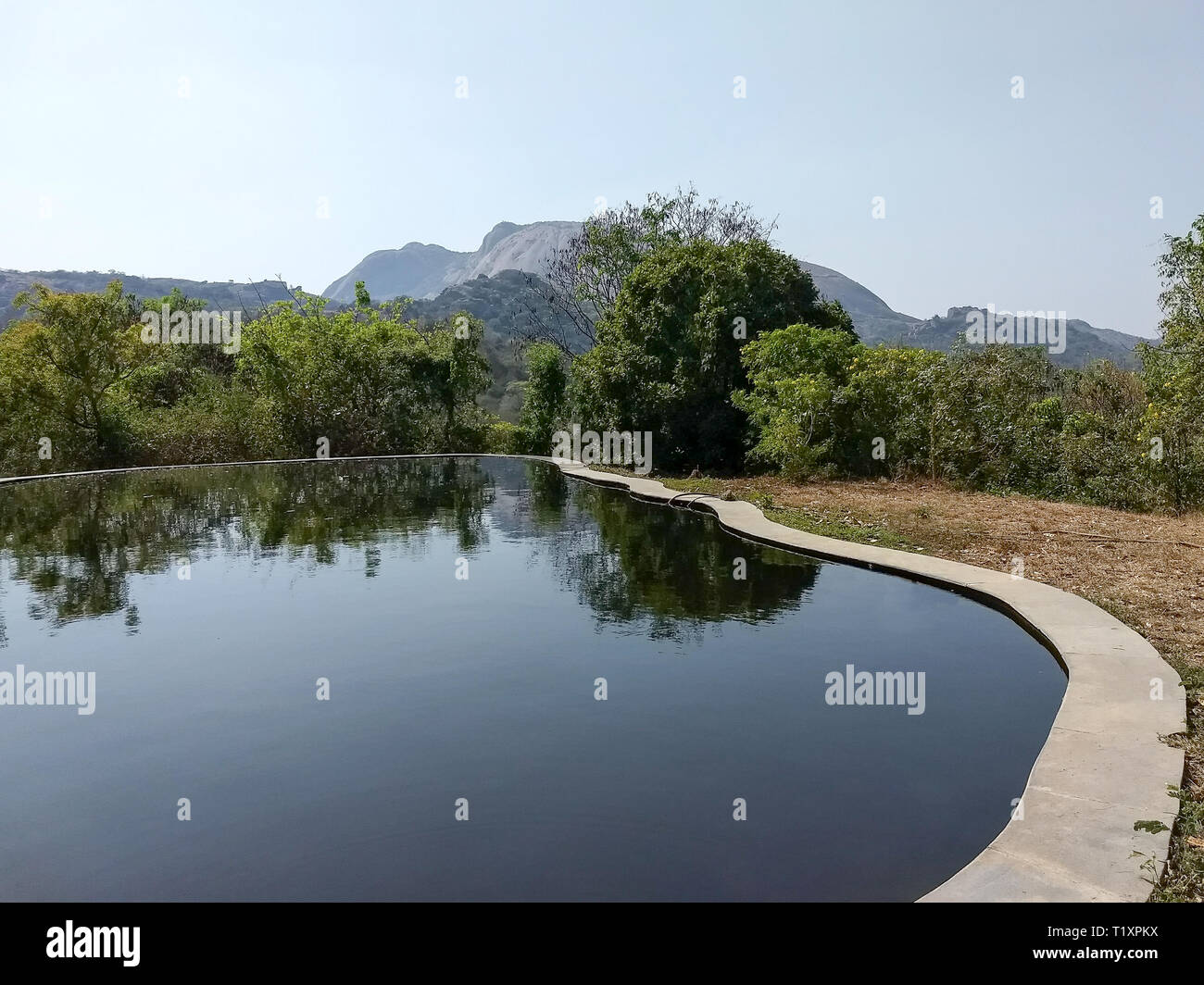 A dark dangerous swimming pool with dark unhealthy water Stock Photo