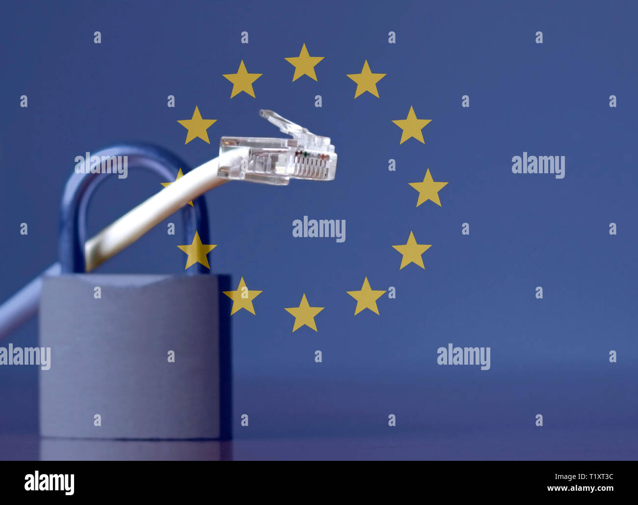 Network cable going through a padlock and the European Union flag Stock Photo
