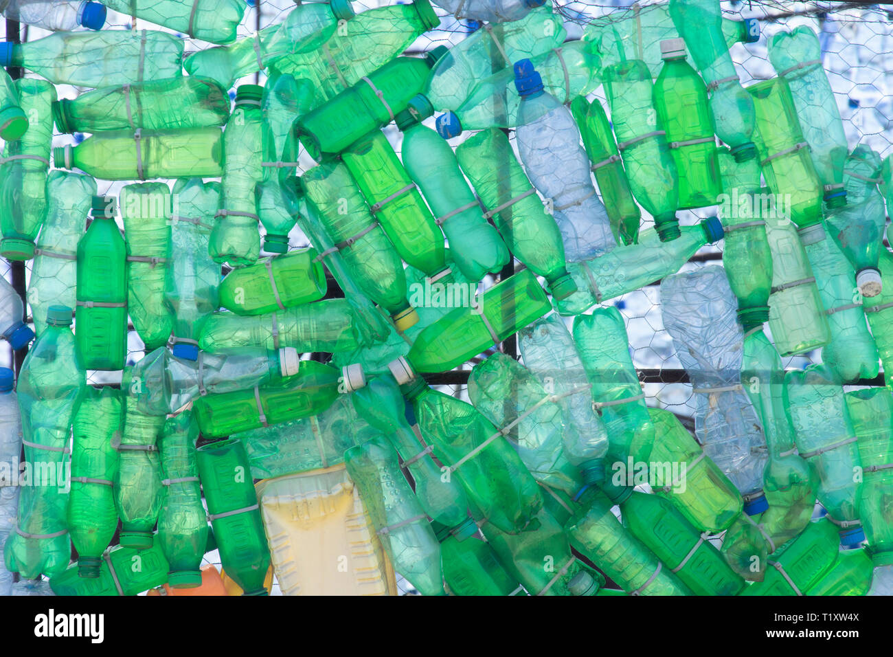 Green waste plastic bottles dumped in nature Stock Photo